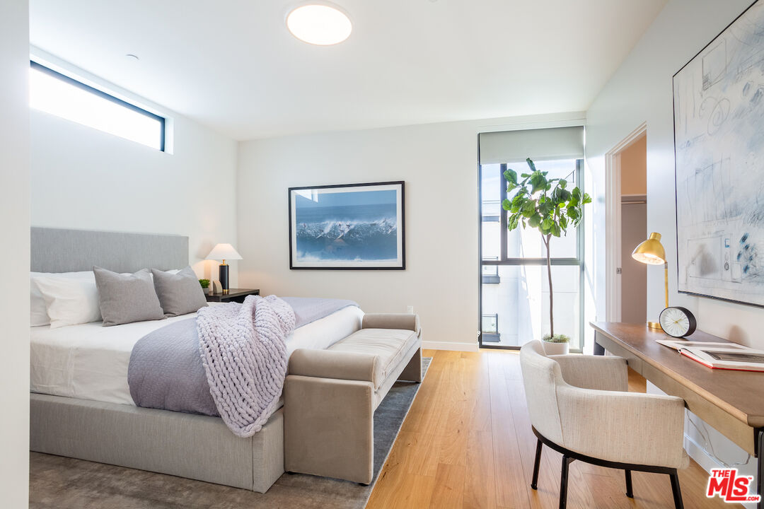 11600 Dunstan Way, Unit 214 Los Angeles, CA 90049 - Photo 10 of 12 a living room with a bed furniture and a window
