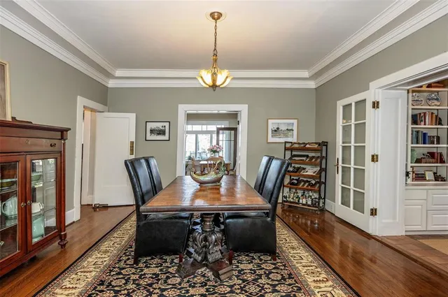 a dining room with furniture a rug and wooden floor