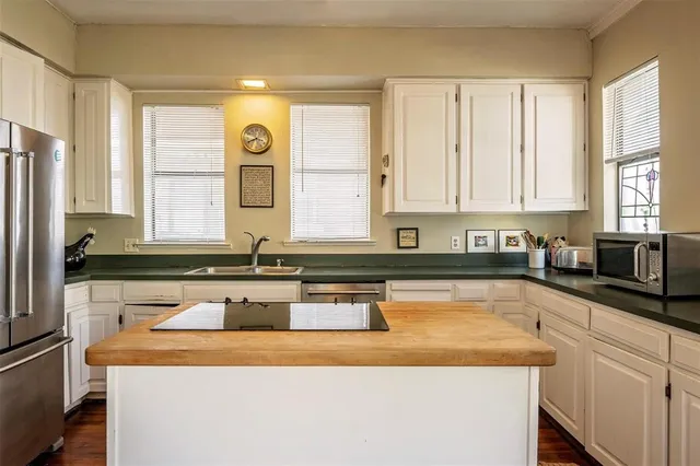 a kitchen with stainless steel appliances granite countertop a sink and a granite counter tops with a large window