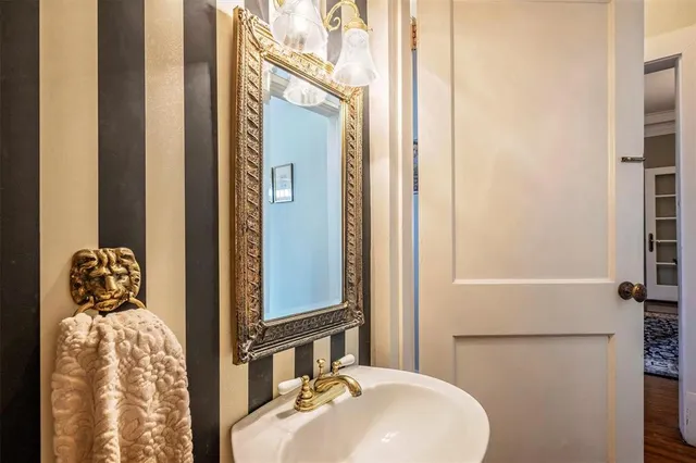a bathroom with a sink and mirror with toilet