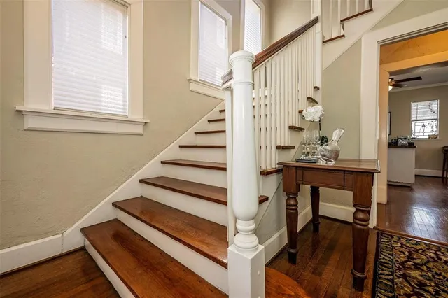 a view of entryway and hall with wooden floor