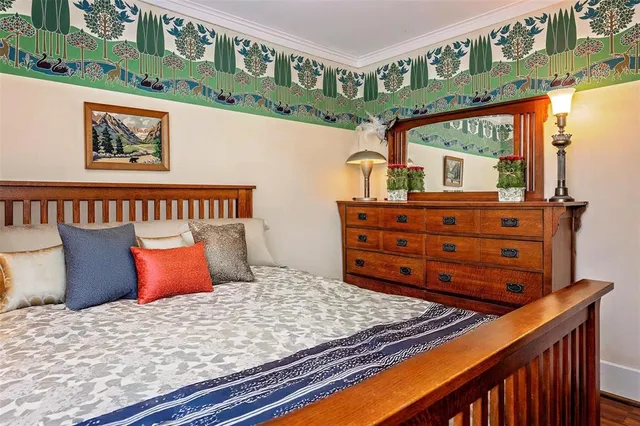 a bed sitting in a bedroom next to a window