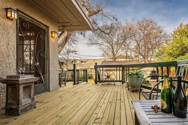 a view of a balcony with chairs and wooden floor