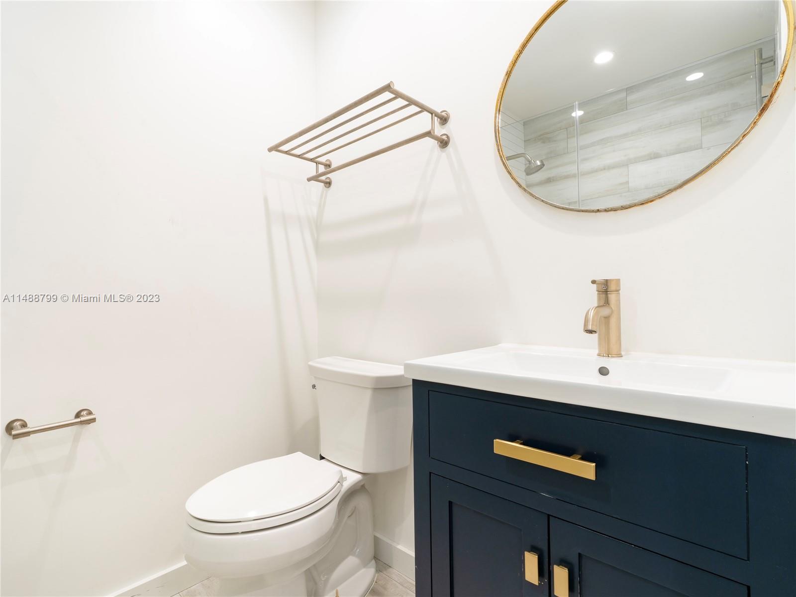 8236 Southwest 103rd Avenue Miami, FL 33173 - Photo 14 of 24 a bathroom with a sink a toilet and a mirror