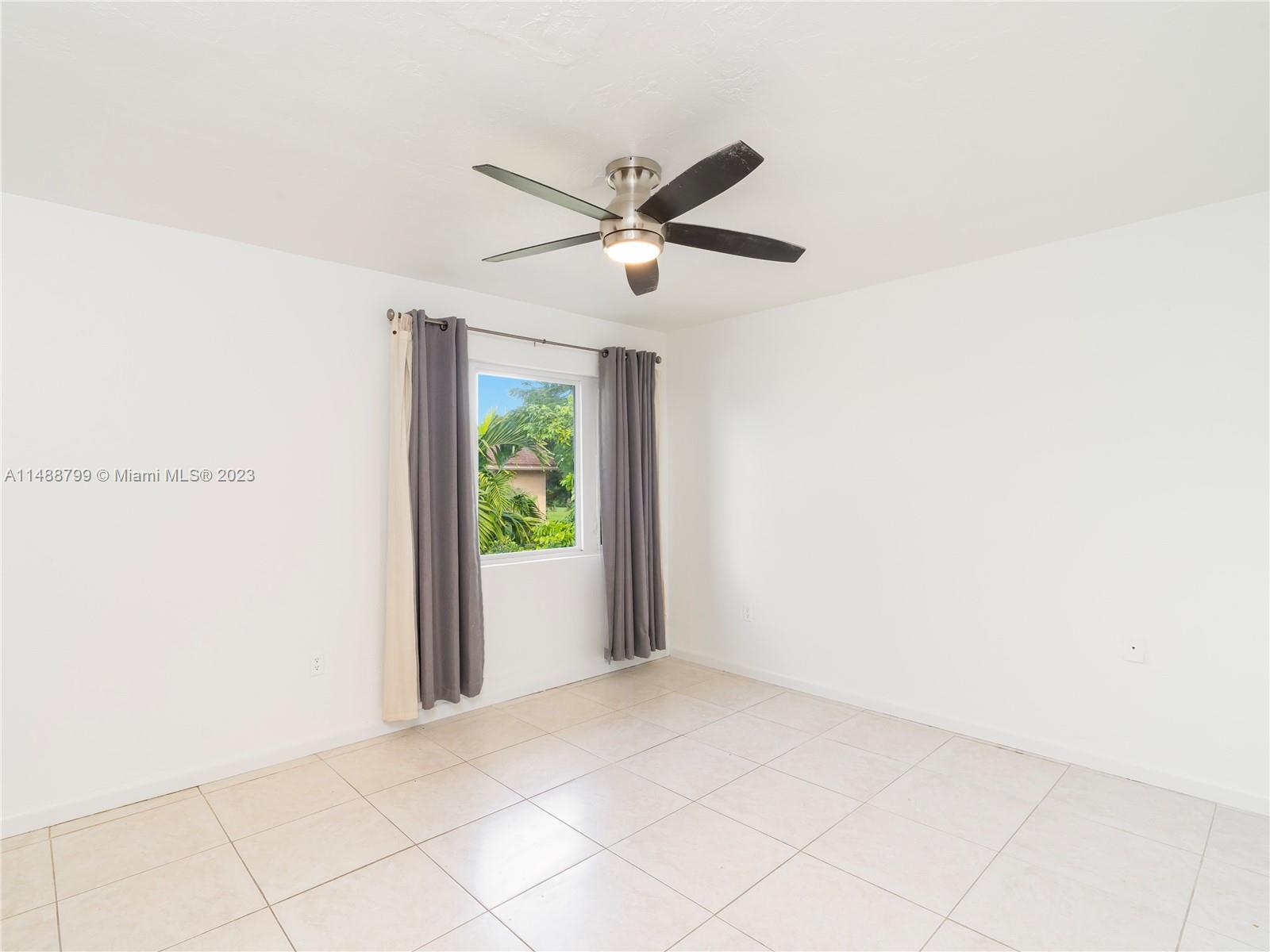 8236 Southwest 103rd Avenue Miami, FL 33173 - Photo 16 of 24 a view of a livingroom with a ceiling fan and window