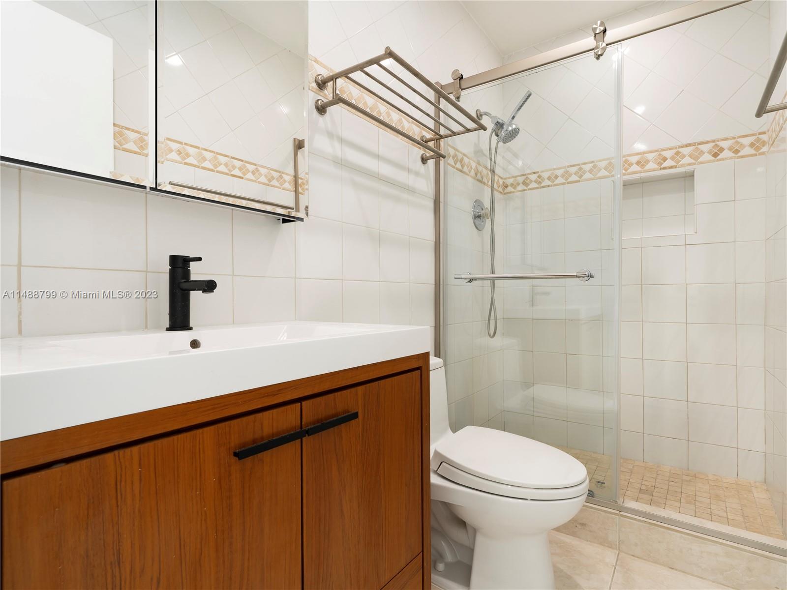 8236 Southwest 103rd Avenue Miami, FL 33173 - Photo 19 of 24 a bathroom with a sink a toilet and shower