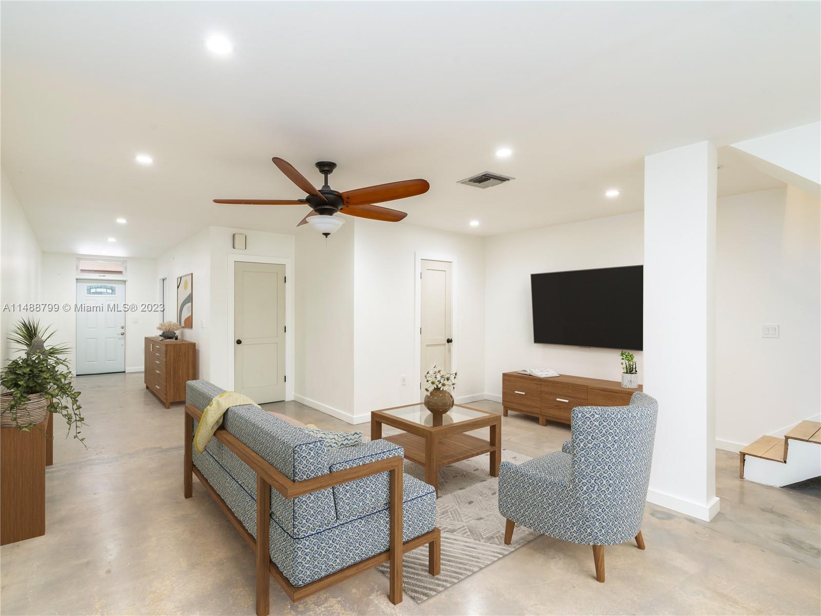 8236 Southwest 103rd Avenue Miami, FL 33173 - Photo 5 of 24 a living room with furniture and a flat screen tv