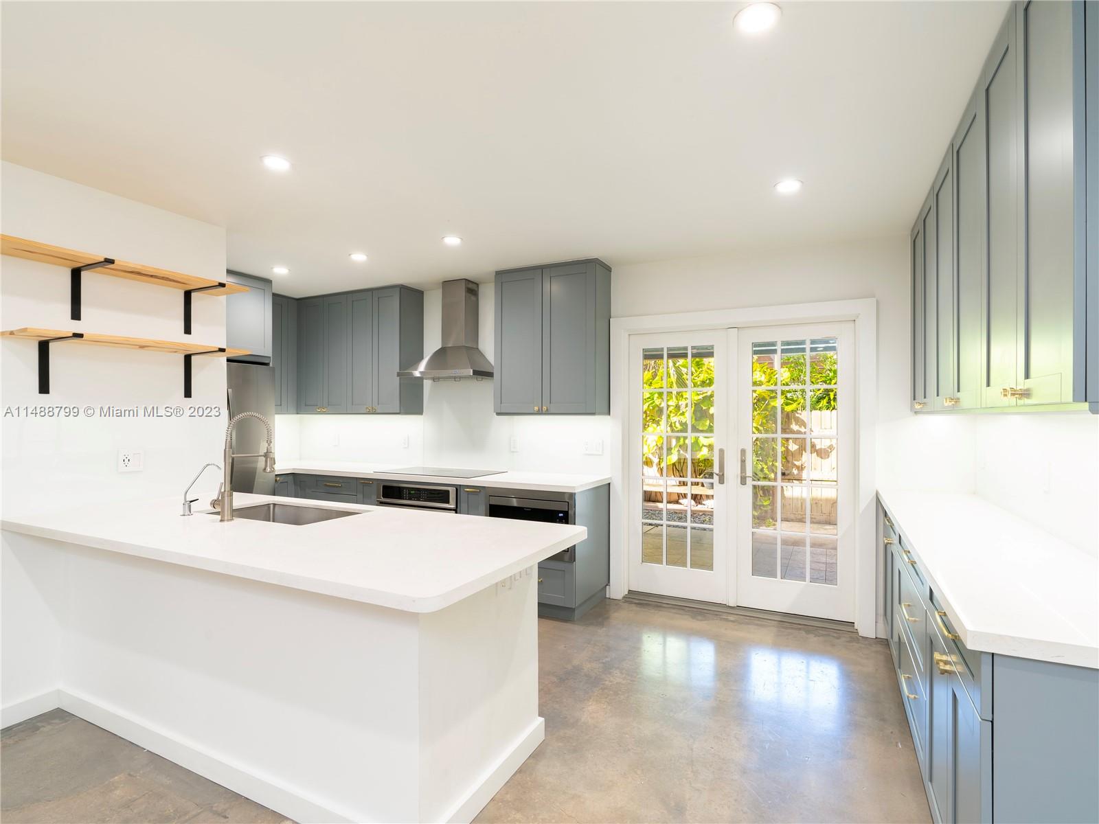 8236 Southwest 103rd Avenue Miami, FL 33173 - Photo 7 of 24 a kitchen with a stove a sink and a refrigerator
