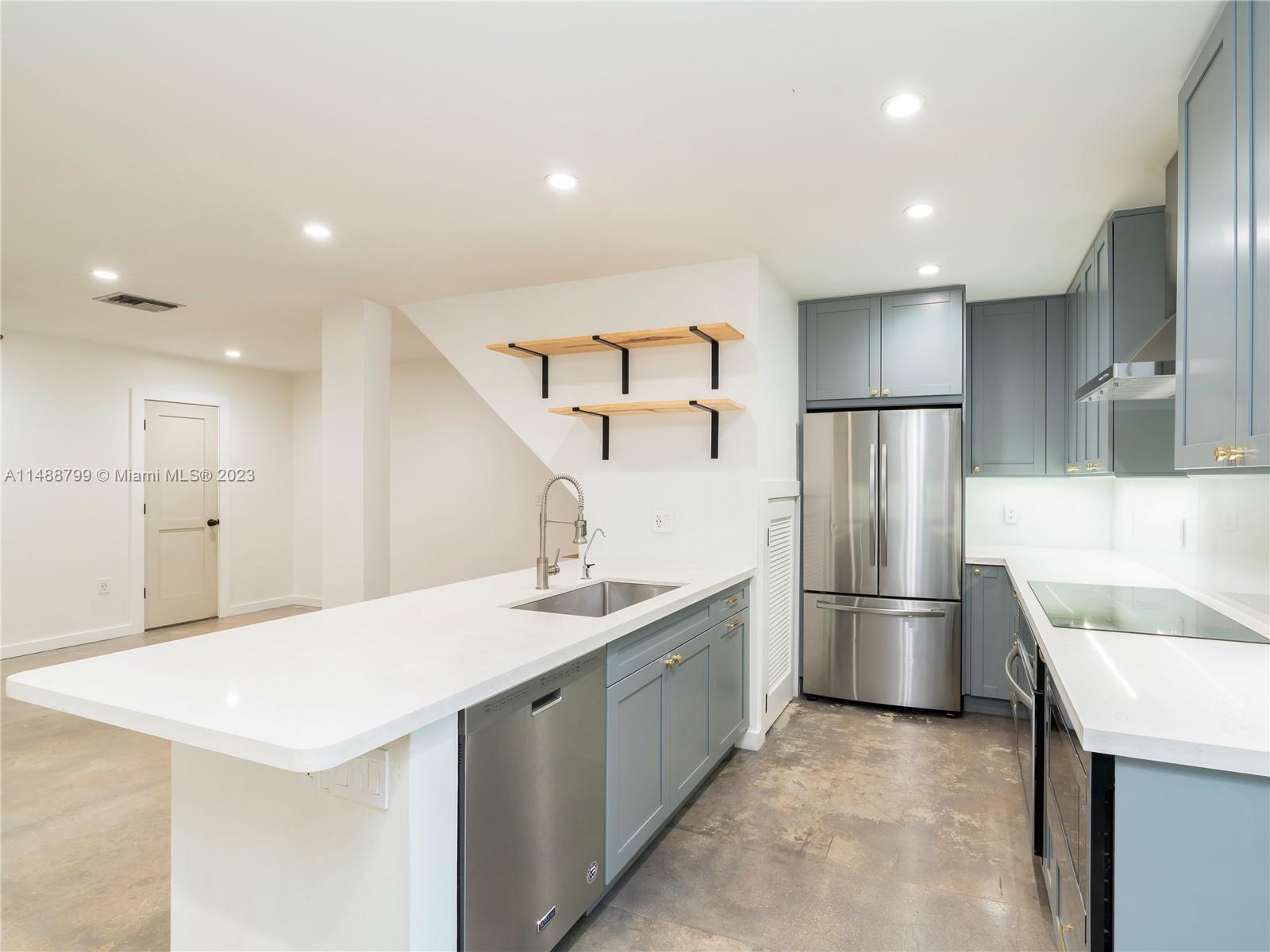 8236 Southwest 103rd Avenue Miami, FL 33173 - Photo 8 of 24 a kitchen with stainless steel appliances kitchen island a sink dishwasher a refrigerator and a sink
