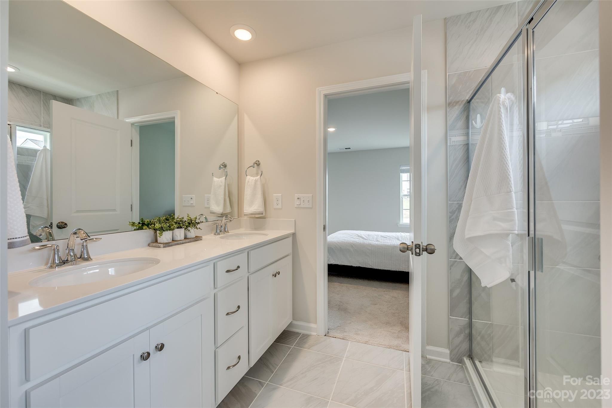 6500 Gopher Road Lancaster, SC 29720 - Photo 25 of 38 a en suite bathroom with a double sink shower and a mirror