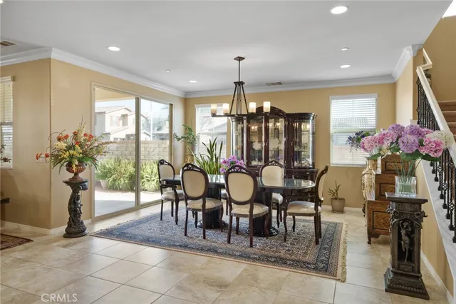 a view of a dining room with furniture and a chandelier