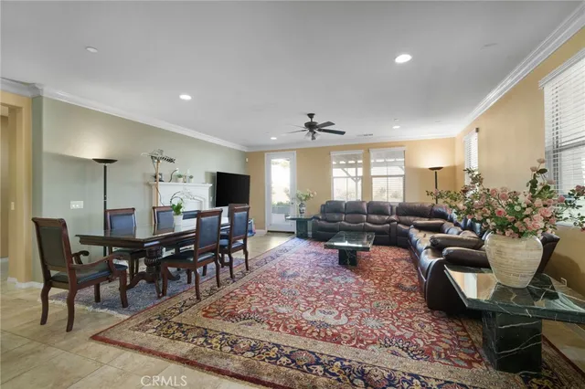 a living room with furniture a dining table and large window