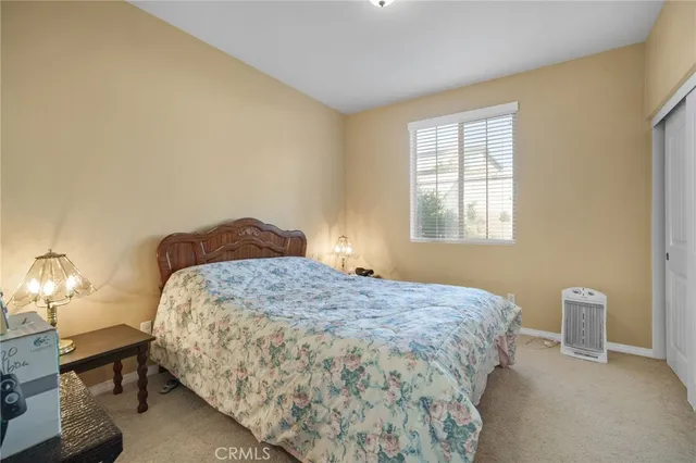 a bedroom with a bed and a lamp with window