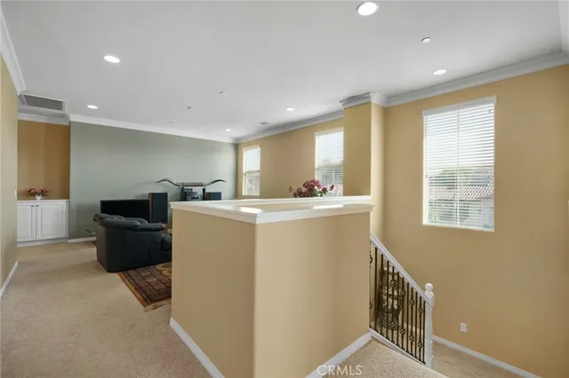 a living room with furniture and flowers