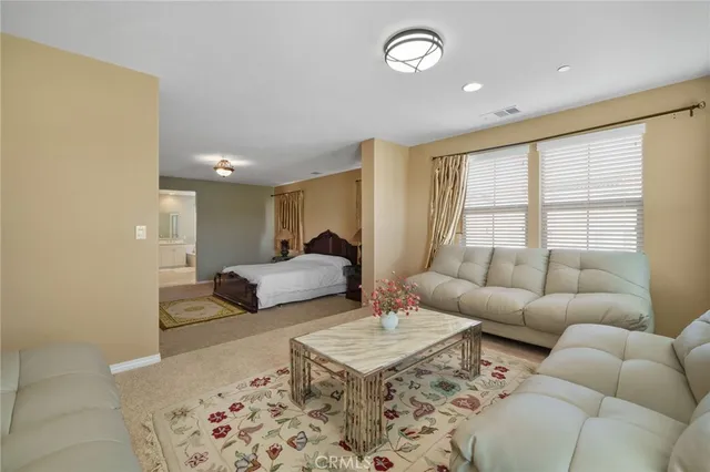 a spacious bathroom with a granite countertop sink mirror and bathtub