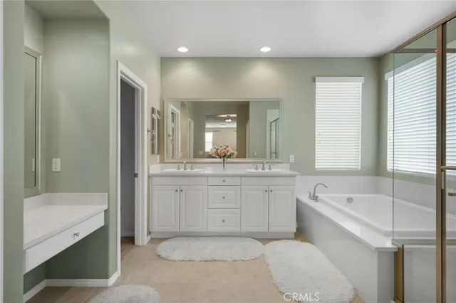 a bathroom with a granite countertop sink a toilet and shower
