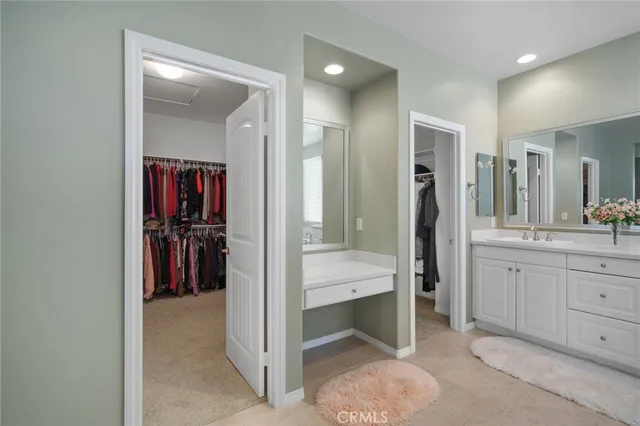 a view of walk in closet with clothes