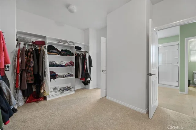 a spacious bedroom with a bed and window