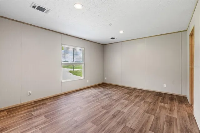 a view of room with window and wooden floor
