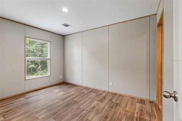 a view of balcony with wooden floor and fence