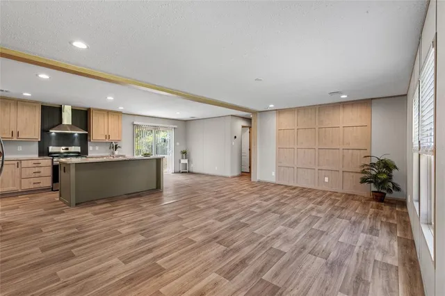 a view of kitchen with wooden floor and electronic appliances