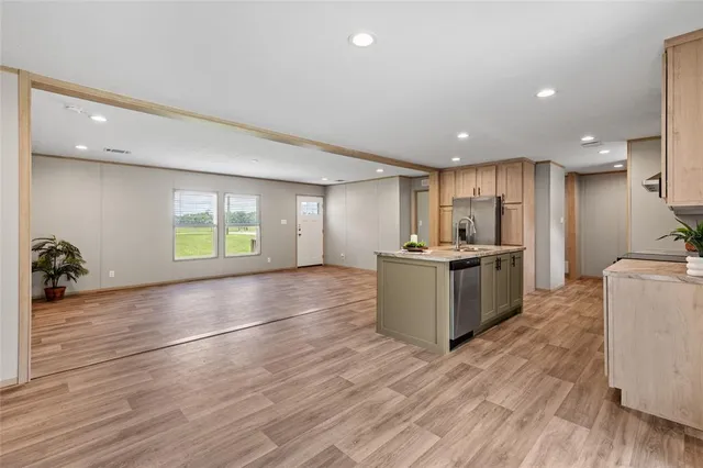 a view of a kitchen with furniture and wooden floor