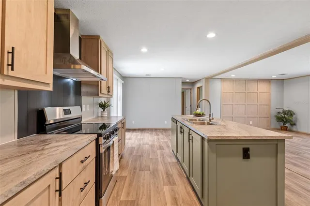 a kitchen with a sink stove and cabinets