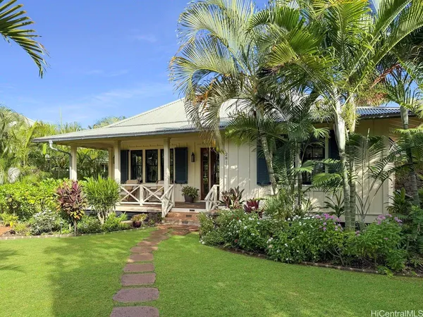 a view of a house with sitting area and garden