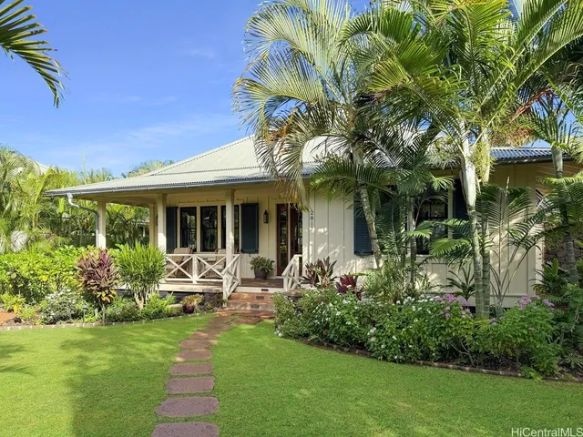 a view of a house with sitting area and garden