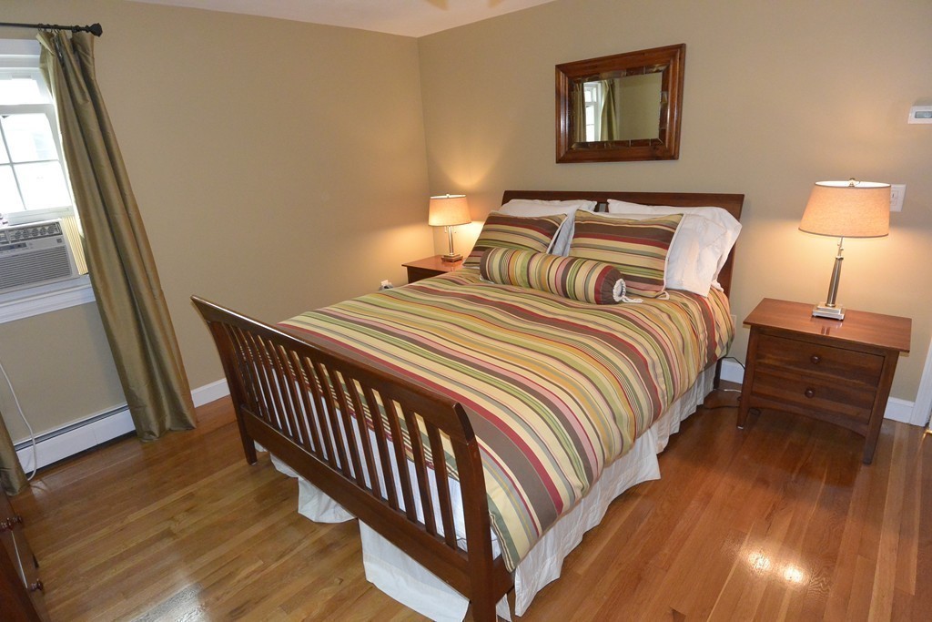 6 Stonybrook Road Medfield, MA 02052 - Photo 21 of 25 a bedroom with a bed and wooden floor