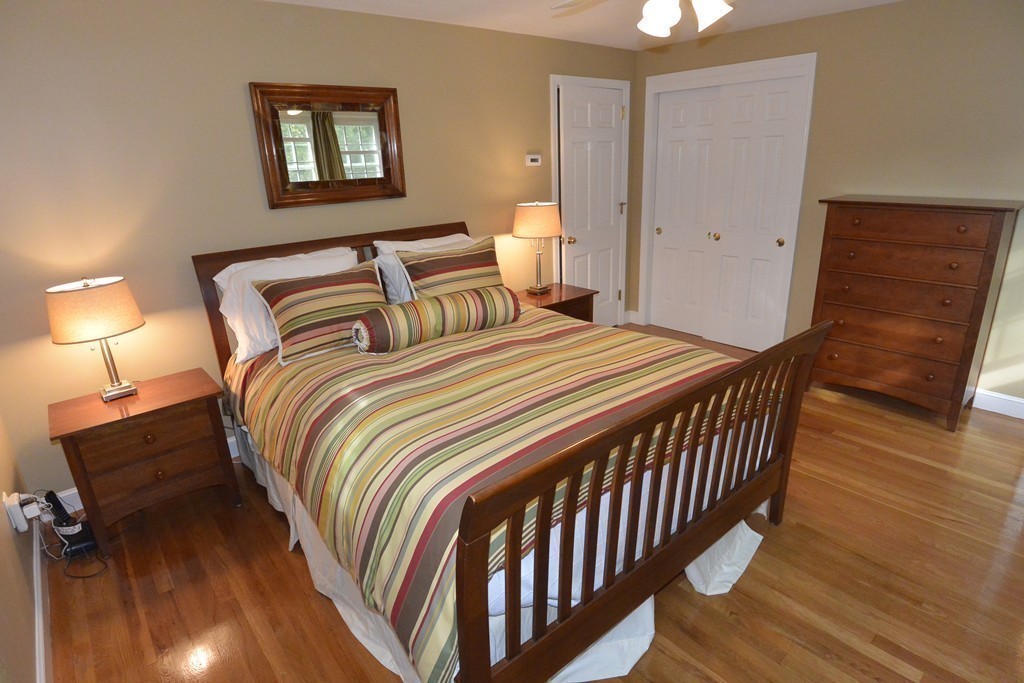 6 Stonybrook Road Medfield, MA 02052 - Photo 22 of 25 a bedroom with a bed and wooden floor