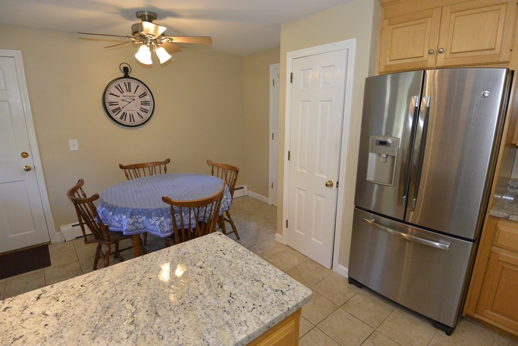 6 Stonybrook Road Medfield, MA 02052 - Photo 7 of 25 a view of a dining table and a refrigerator in a kitchen