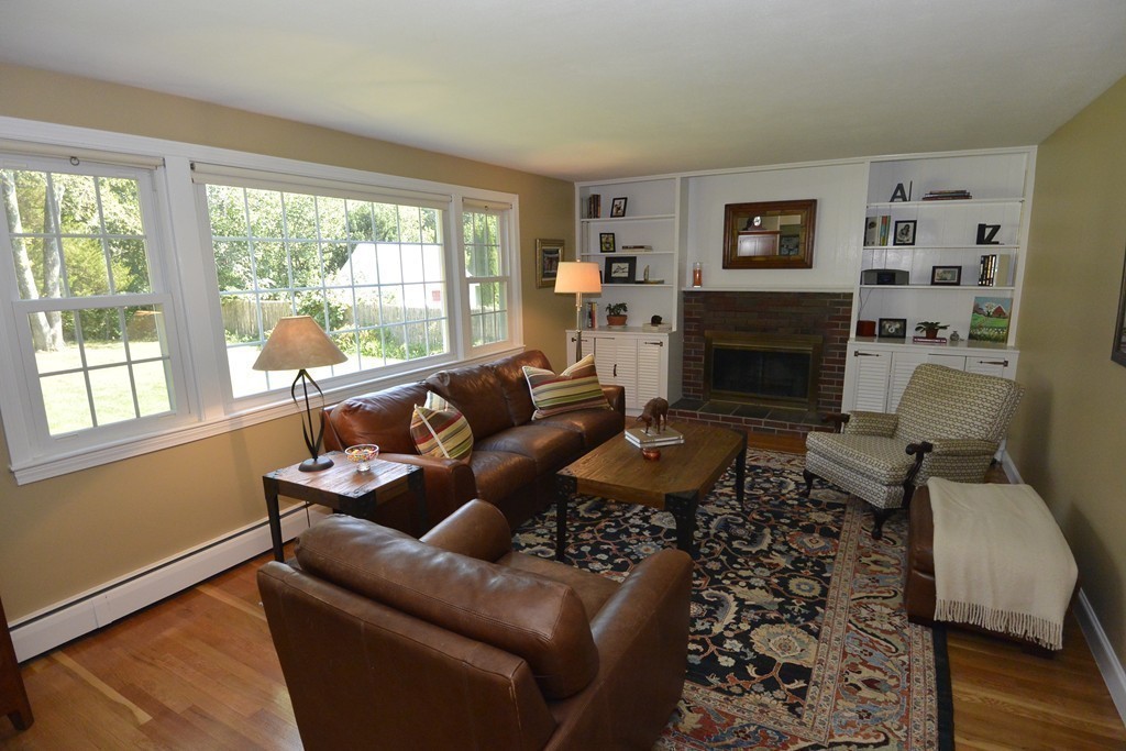 6 Stonybrook Road Medfield, MA 02052 - Photo 8 of 25 a living room with furniture a large window and a fireplace
