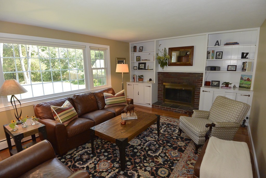 6 Stonybrook Road Medfield, MA 02052 - Photo 9 of 25 a living room with furniture a large window and a fireplace