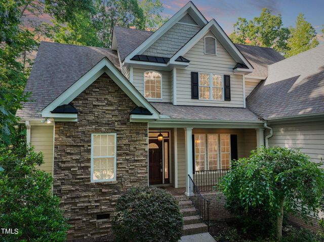 a view of a house with brick walls and potted plants