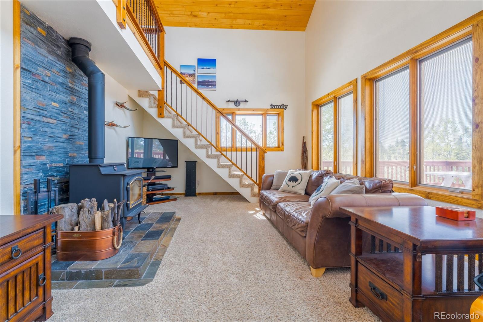 8221 Remington Road Como, CO 80432 - Photo 15 of 49 a living room with furniture a bookshelf and a large window