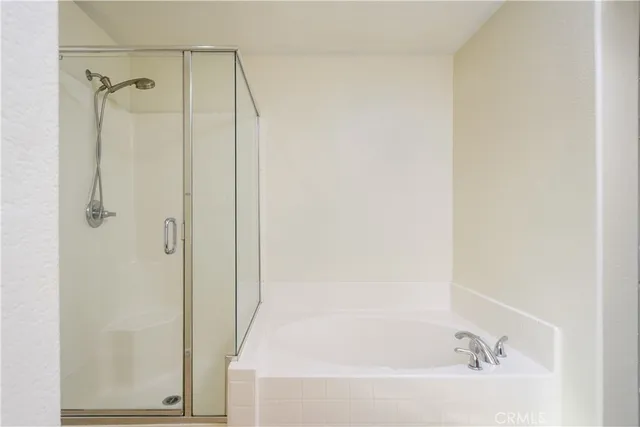 a bathroom with a bathtub and a shower