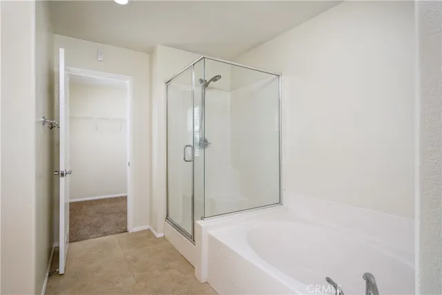 a small space with a window and hardwood floor