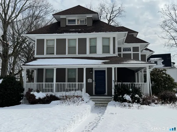 a front view of a house with a yard and parking space