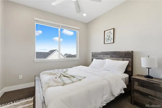 a bedroom with a bed and a painting