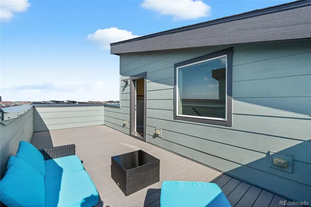 an aerial view of a swimming pool with outdoor space and seating area