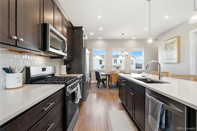 a kitchen with counter top space and wooden floor