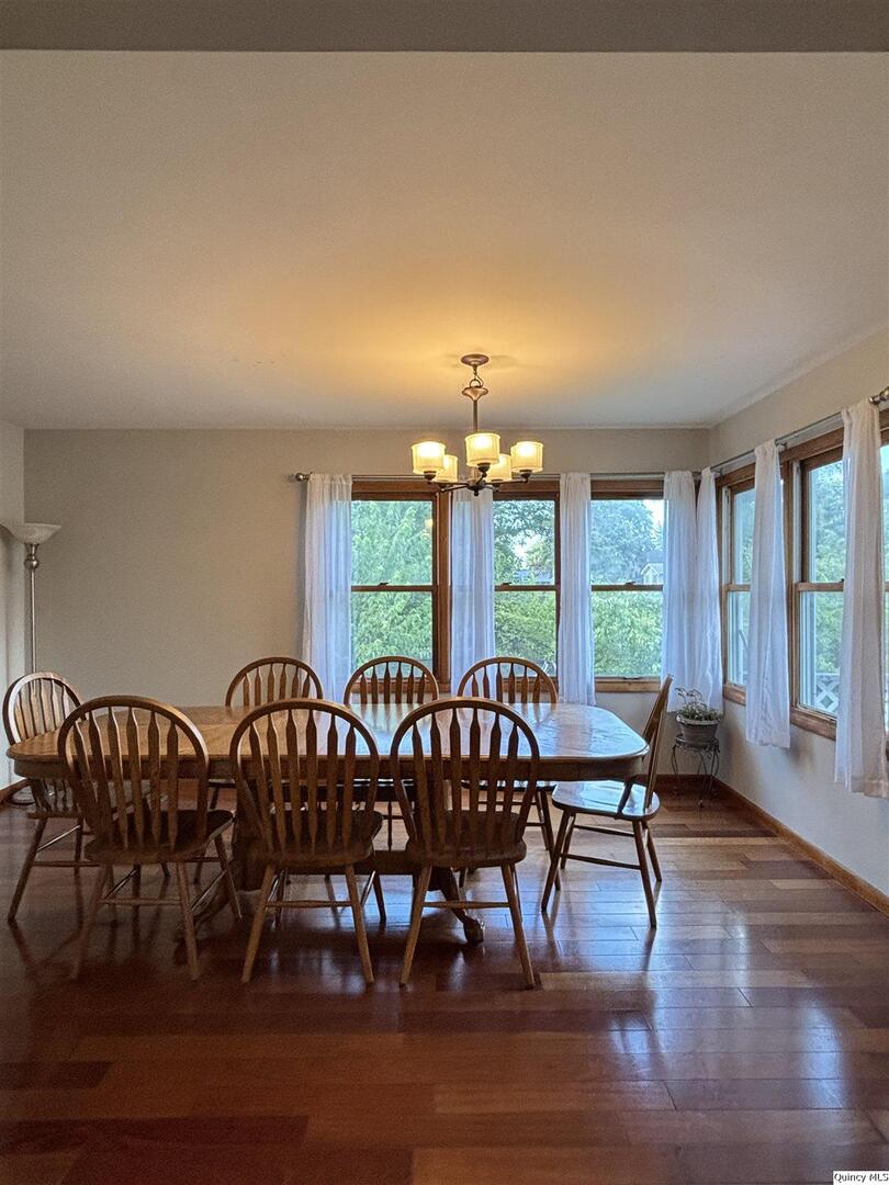 802 West Main Street La Harpe, IL 61450 - Photo 15 of 25 a view of a dining room with furniture window and wooden floor