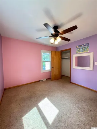 a view of a livingroom with a ceiling fan and window