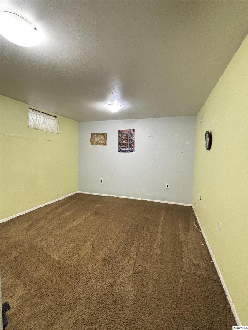 802 West Main Street La Harpe, IL 61450 - Photo 24 of 25 an empty room with a projector