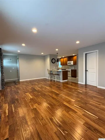 a room with a flat screen tv and a fireplace
