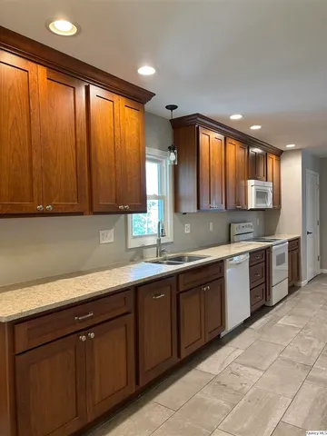 a kitchen with a sink window and cabinets