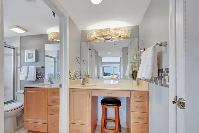 a bedroom with a bed and a lamp next to a window