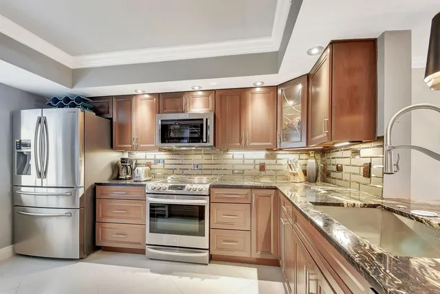 a kitchen with stainless steel appliances granite countertop a sink and cabinets