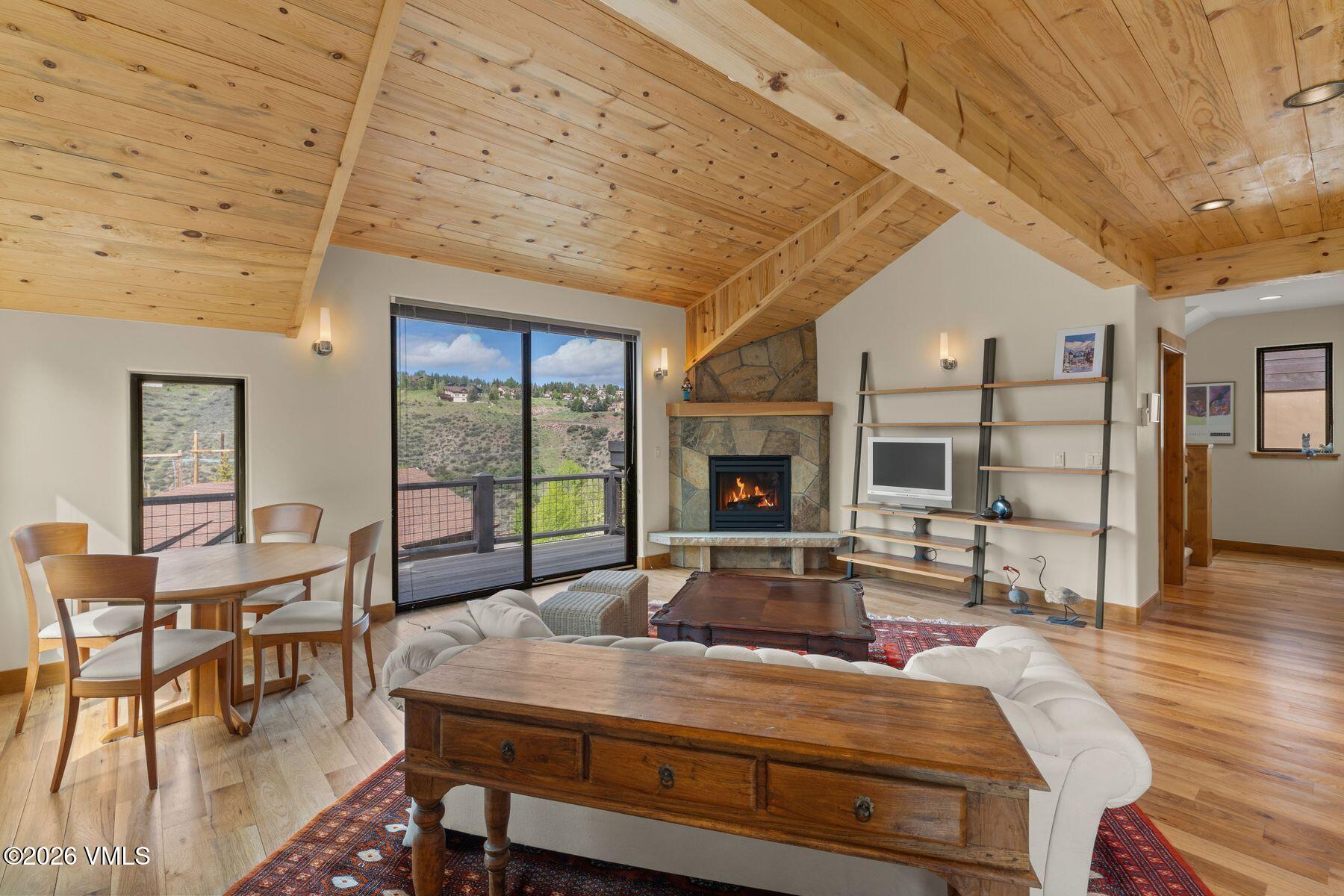 1015 West Wildwood Road, Unit F Avon, CO 81620 - Photo 3 of 35 a living room with furniture a fireplace and a table